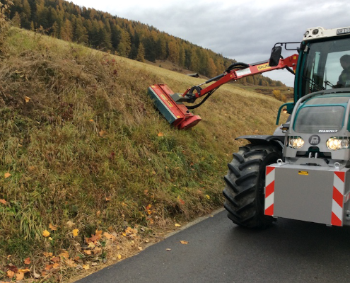 Spreading mulcher in use for road maintenance